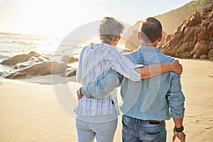 Beach, love and an old couple walking on the sand by the ocean or sea for romance or dating at sunset. Nature, summer or