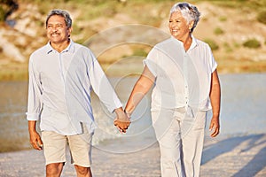 Beach, love and retirement, a senior couple holding hands and walking in the sand. Health, sunshine and recreation for