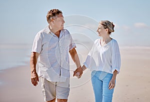 Beach, love and senior couple holding hands while walking for health, exercise and wellness. Happy, romance and elderly