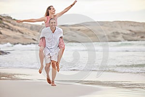 Beach, love and summer couple walking on sand together for relaxing date with piggy back. Young, happy and playful