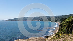 Beach lovers facing the Pacific Ocean from the fort of Niebla village. Estuary and mouth of the Valdivia River. Valdivia, Los Rios photo