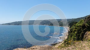 Beach lovers facing the Pacific Ocean from the fort of Niebla village. Estuary and mouth of the Valdivia River. Valdivia, Los Rios photo