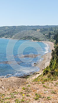 Beach lovers facing the Pacific Ocean from the fort of Niebla village. Estuary and mouth of the Valdivia River. Valdivia, Los Rios photo