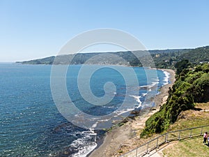 Beach lovers facing the Pacific Ocean from the fort of Niebla village. Estuary and mouth of the Valdivia River. Valdivia, Los Rios photo