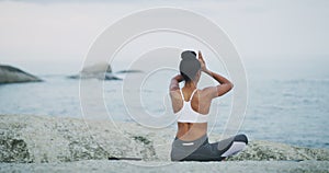 Beach, meditation and woman doing a yoga exercise for calm mindset, balance and health. Nature, zen and back of female