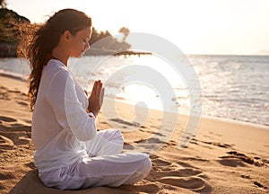 Beach, meditation or woman with prayer hands in nature at sunset for peace, zen or mental health wellness. Spiritual