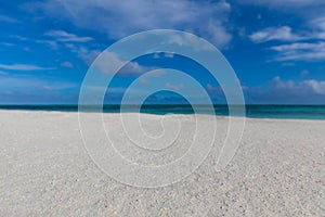 Beach minimal. White sand blue sunny sky clouds. Idyllic beachfront, shoreline closeup
