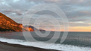 Beach with mountain, sunset over ocean, natural landscape, dusk horizon