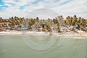 The beach in Mui Ne village. Palm trees, resort houses, street cafes. Province of Binh Thuan, Phan Thiet,