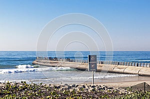 Beach Ocean and Concrete Mier with many Fisherman