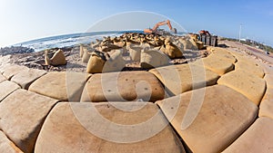 Beach Ocean Excavator Machine Sand Bag Barriers photo