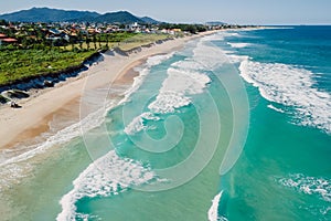 Beach and ocean with surfing waves in Brazil. Aerial view of Morro das Pedras photo