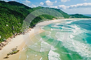 Beach and ocean with waves in Brazil, Florianopolis. Aerial view of Praia da Galheta