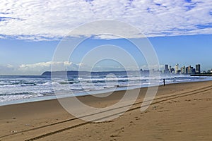 Beach Ocean Waves and Shoreline Against Blue Sky