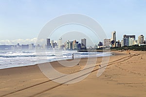 Beach Ocean Waves and Shoreline Against Blue Sky