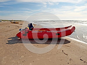 Beach, outdoor and inflatable boat on sand in nature by sea for travel in summer. Dinghy, transport and vessel on