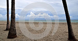 Beach with overcast skyand thick white clouds