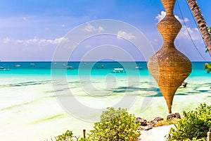 Beach with palm trees and beach beds, summer vacations