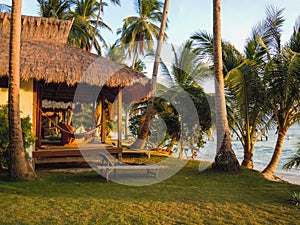 Beach with palm trees and tourist house