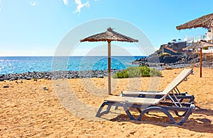 Beach with parasol and sunbeds by the sea photo