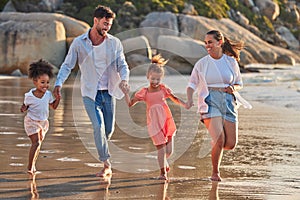 Beach, parents and kids happy, relax and enjoy holiday, vacation and break on sand barefoot. Mom, dad and children smile