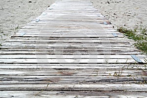 Beach path with planks, sand and textspace