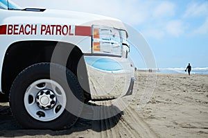 Beach Patrol vehicle at the ocean