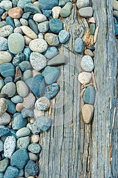 Beach pebbles and driftwood log, British Columbia, Canada.