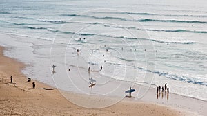 Beach with people swimming and surfing, Portugal, Algarve, Praia do Cordoama