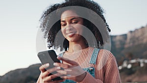 Beach, phone and young woman typing a text message on social media, mobile app or website. Technology, happy and female