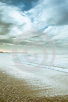 Beach photography - blue ocean waves, sand, overcast sky