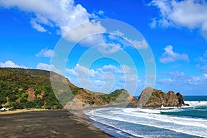 The beach at Piha, New Zealand, looking towards Taitomo Island and Nun Rock