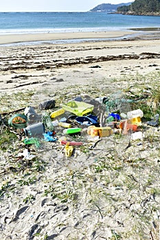 Beach with plastic pollution on sand at famous Rias Baixas Region. Galicia, Spain.