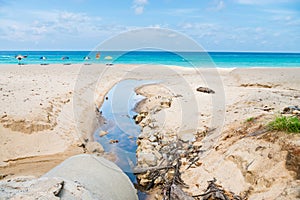 Beach pollution from dirty drainage sewer pipe