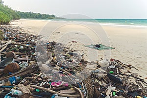 Beach pollution. Plastic bottles and other trash on sea beach