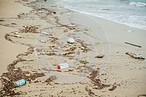 Beach pollution. Plastic bottles and other trash on sea beach