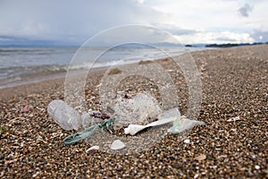 Beach pollution. Plastic bottles and other trash on sea beach. Ocean pollution.