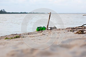 Beach pollution. Plastic bottles and other trash on sea beach. Ecological concept. earth day concept.globe pollution. Garbage on