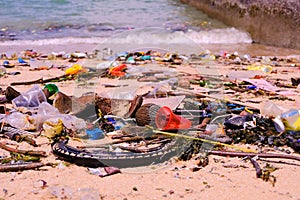 Beach pollution â€” trash of plastics, bottles, other wastes, wa