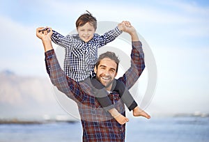 Beach, portrait and happy man with child on shoulders, smile and mockup space on outdoor adventure. Support, face of