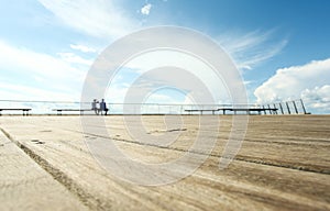 Beach promenade with benches and blue sky