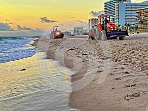 Beach Raker smoothing sand at dawn