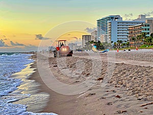 Beach Raker smoothing sand at dawn