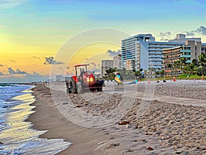 Beach Raker smoothing sand at dawn