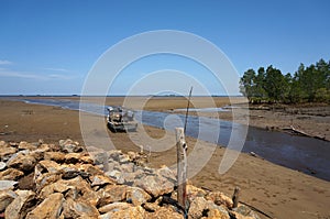 Beach when recede with object wooden fishing boat.