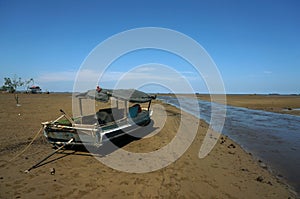 Beach when recede with object wooden fishing boat.