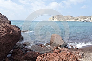 Beach with red sand. The island of Santorini.