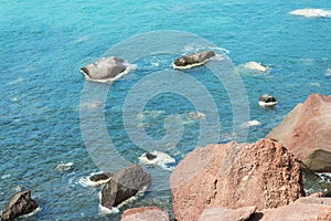 Beach with red sand. The island of Santorini.