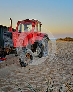 Beach with red tractor at the Baltic Sea. Ahlbeck, Germany