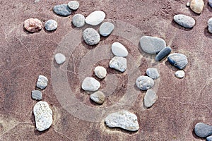 Beach red and yellow sand and sea stones